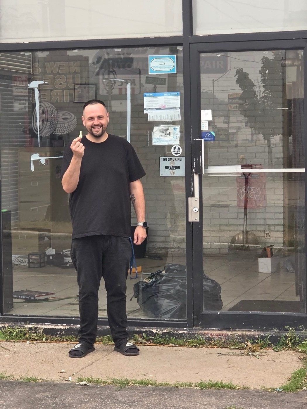 Jon Flewitt holding the keys to the new shop